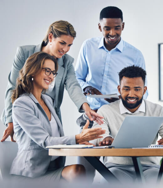 Team of professionals collaborating around a laptop